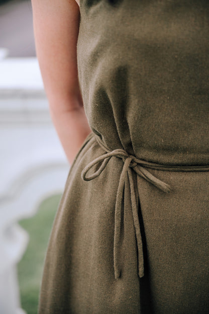 Close up of waist strap of woman wearing MOSS Isla Dress in breathable moss green linen blend