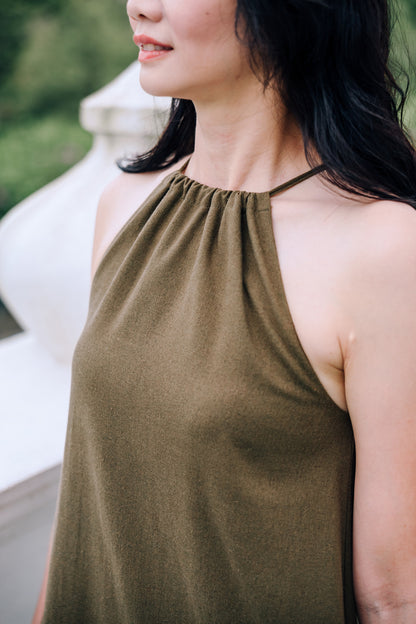 Close up of halter neck of woman wearing MOSS Isla Dress in breathable moss green linen blend