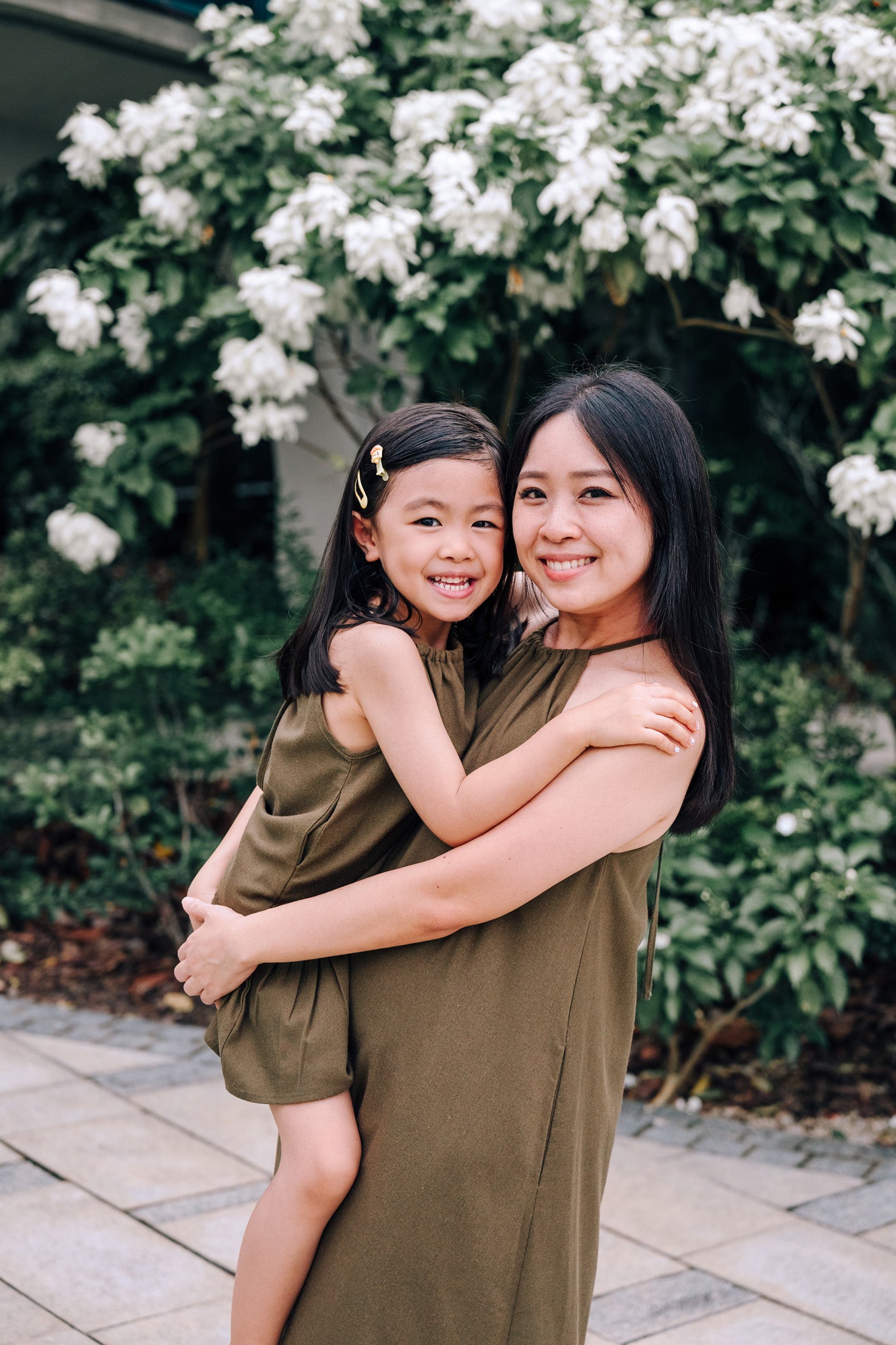 Mother and Daughter wearing matching  MOSS Isla Dress & Mini Isla Dress in soft moss green linen blend fabric