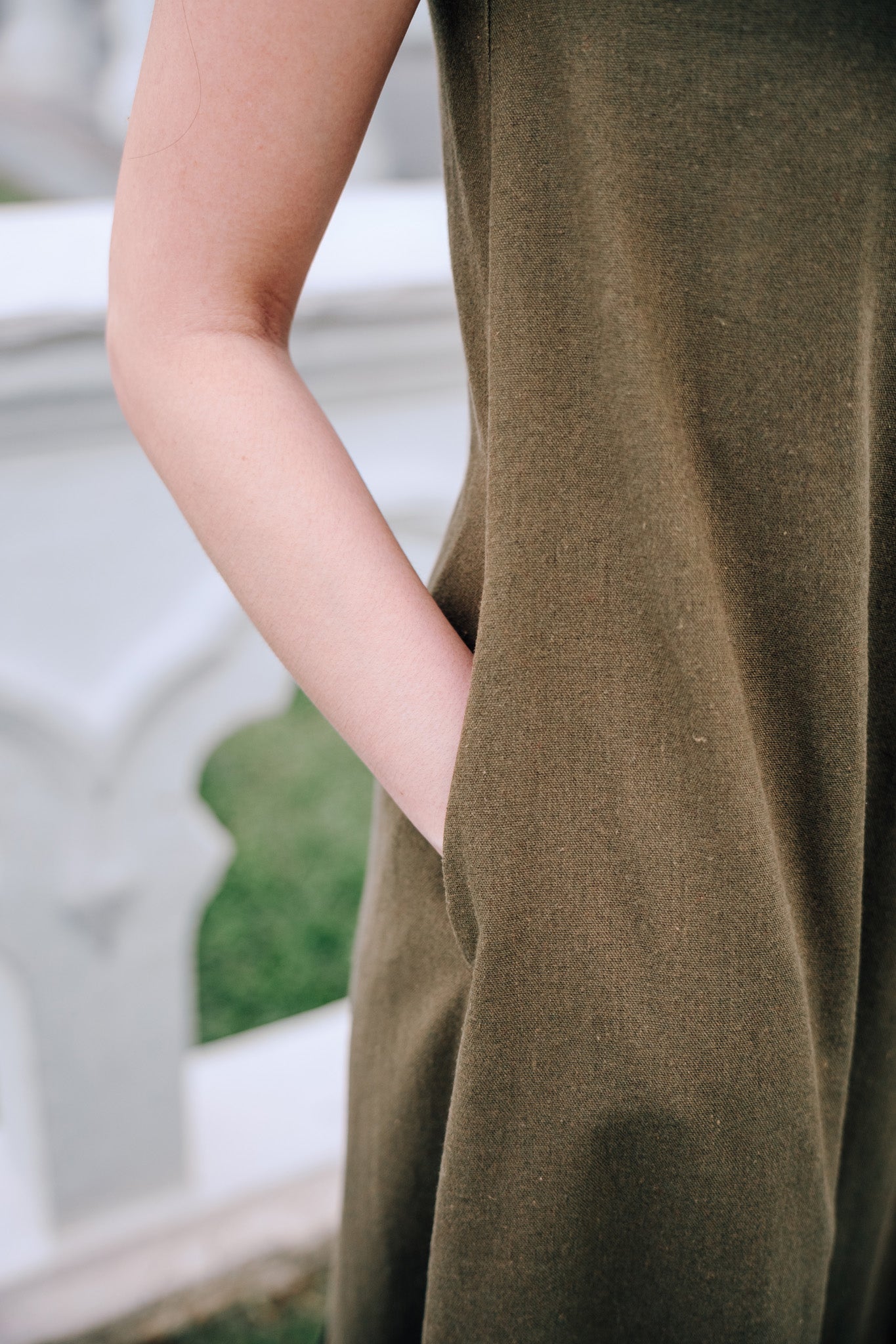 Close up of side pocket of woman wearing MOSS Isla Dress in breathable moss green linen blend