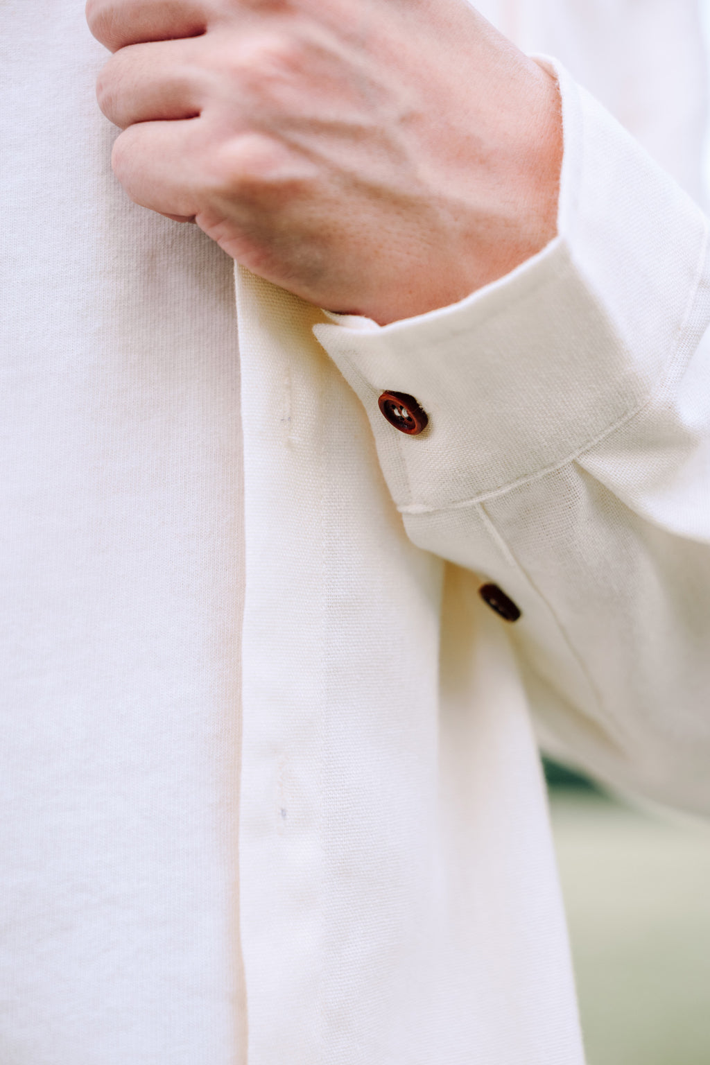 Close up of cuff of man wearing SAND Elio Shirt in breathable sand linen blend