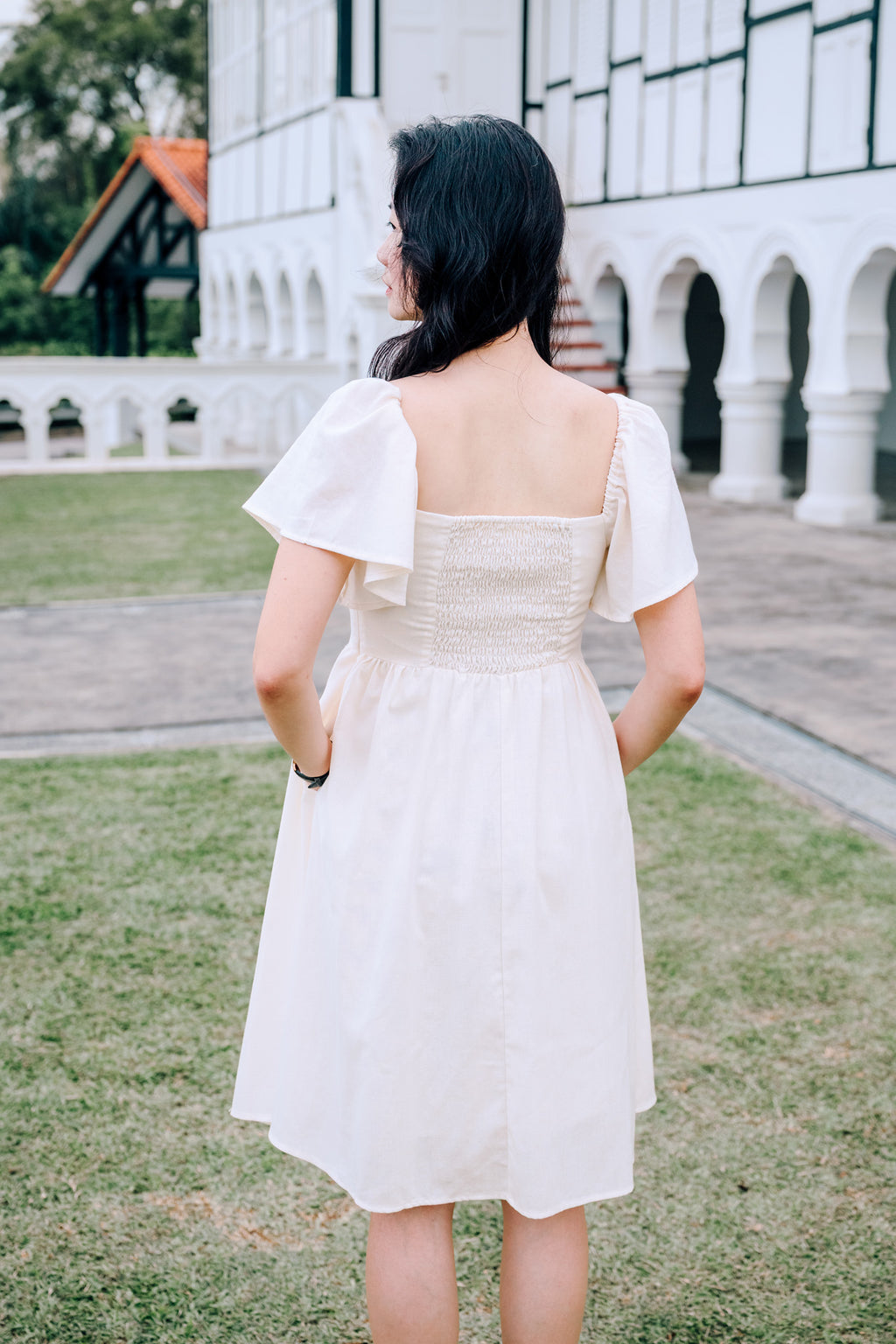 Back View of SAND Mira A-Line Dress smocked back and ruffle sleeves in sand, family/couple matching available