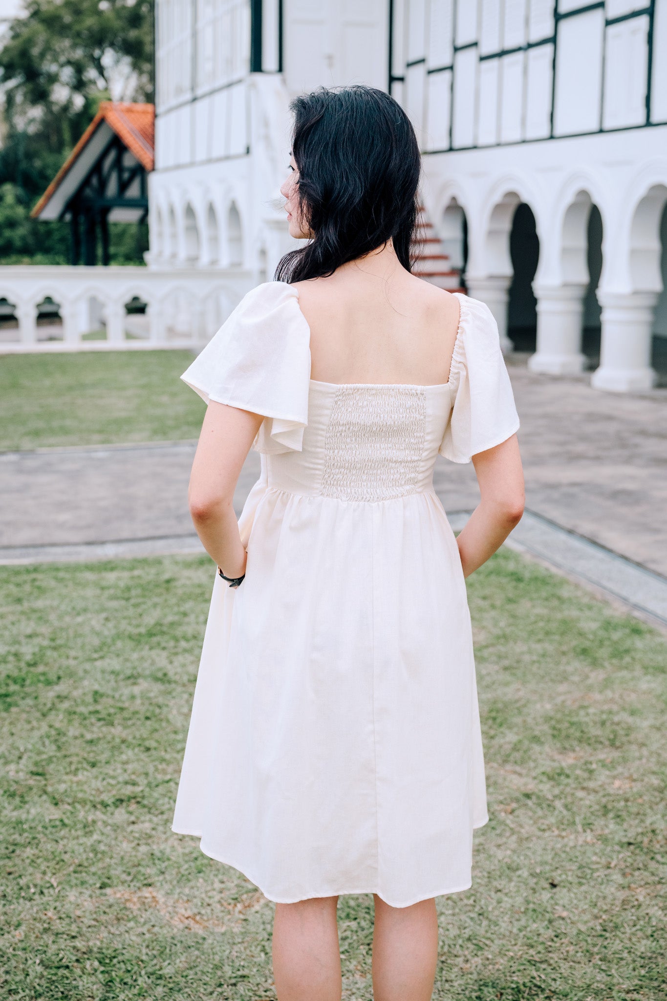 Back View of SAND Mira A-Line Dress smocked back and ruffle sleeves in sand, family/couple matching available