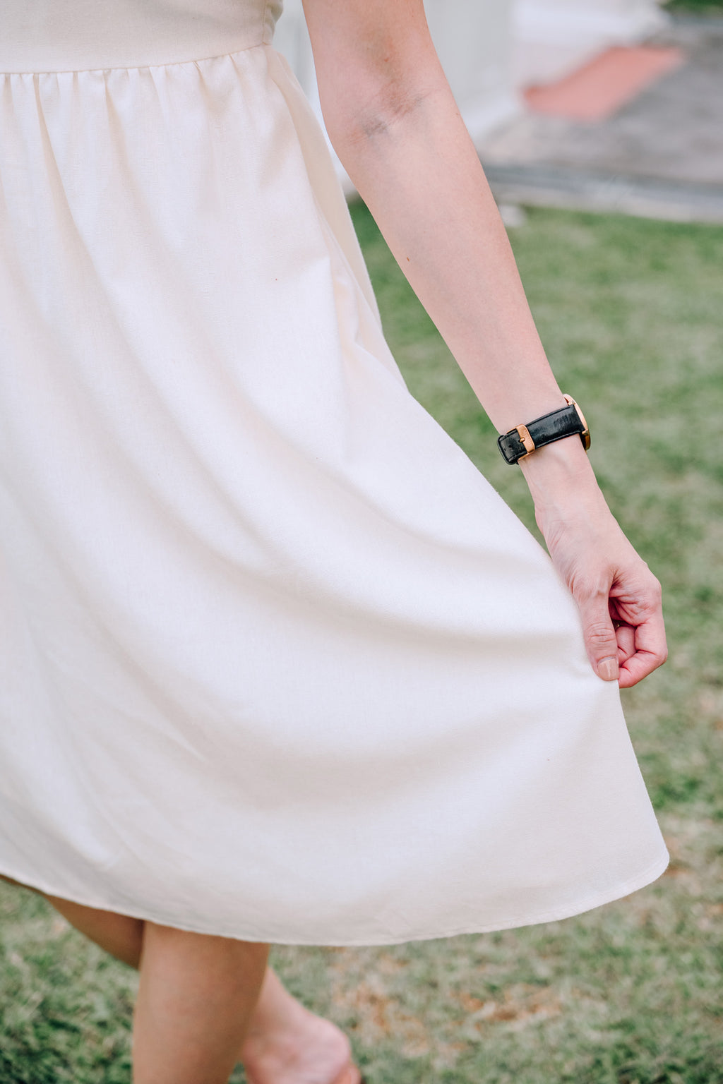 Close-up of SAND Mira A-Line Dress smocked back and ruffle sleeves in sand