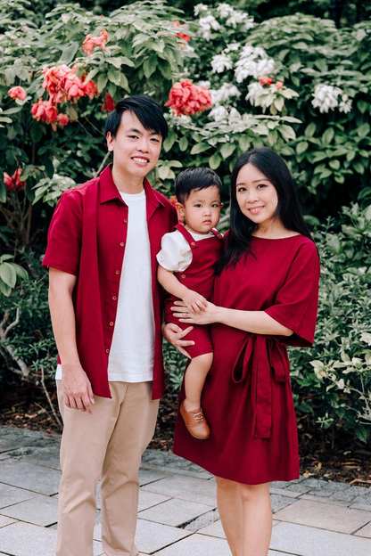 Family wearing matching burgundy linen shirt, linen dungaree and linen dress.
