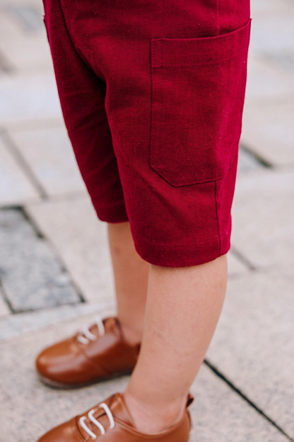 Close up of side pocket of bungundy kids linen dungaree